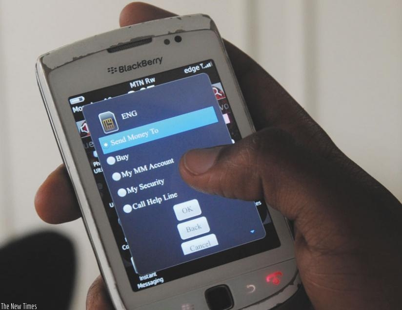 An MTN client makes a mobile money transaction. Mobile money subscribers will soon be able to send or receive money to and from Kenya and Tanzania. (File)