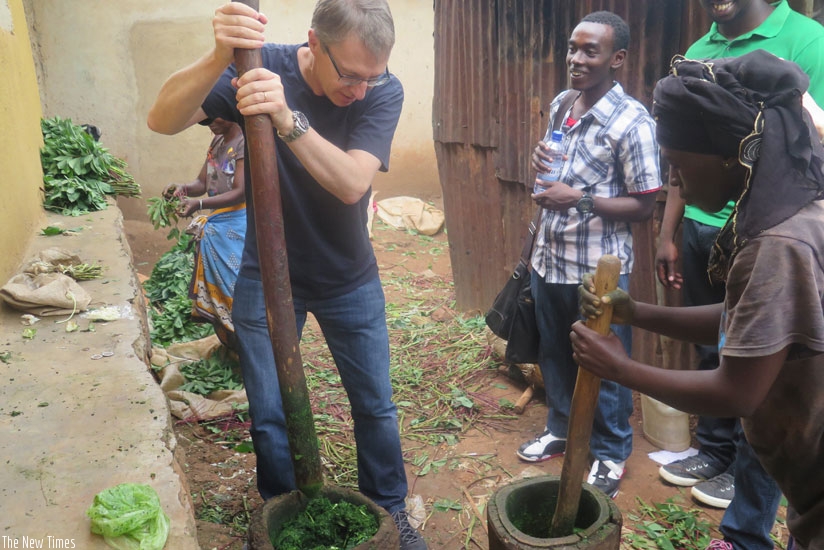 A tourist pounding isombe.