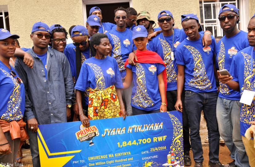 The artistes and Bralirwa officials pose for a photo with Uwimbabazi at her home.