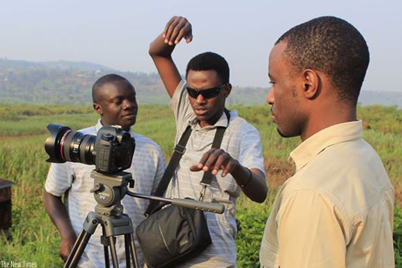 Philbert Aime Mbabazi (middle) and his crew on a set during a shooting session. (Courtesy).