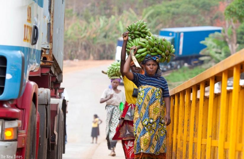 Traders from the Tanzanian side of the border cross to Rwanda at Rusumo border. (Timothy Kisambira)