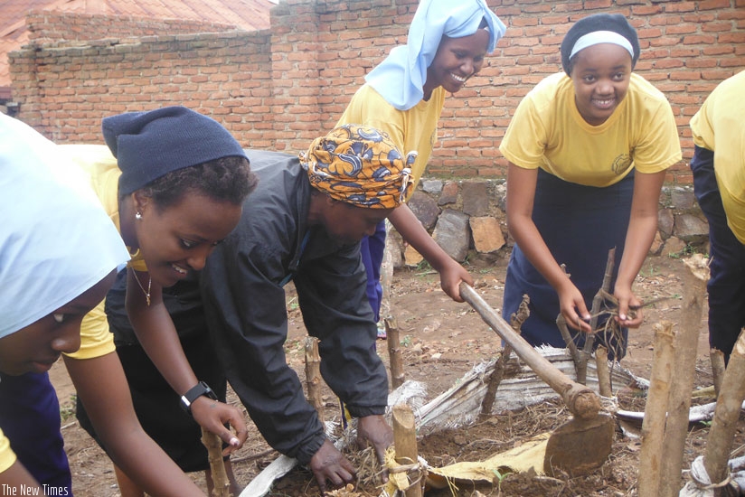 Students establish a vegetable garden for Nzanywayimana recently. (Dennis Agaba)