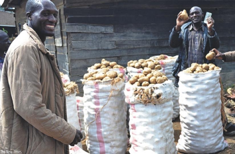 Dealers wait for a vehicle to transport Irish potatoes. A wholesale market for Irish potato will be set up in Kigali.