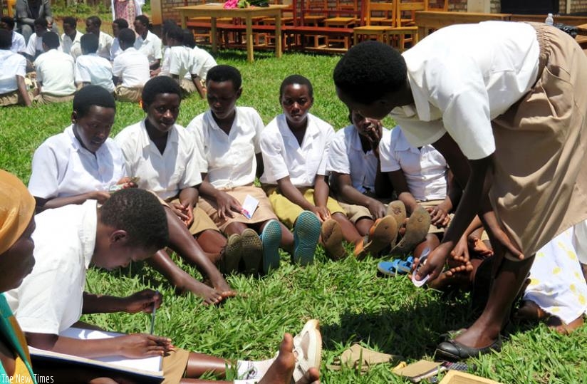 Female students at GS Runyinya engage in savings practice as a club on Tuesday. The practice is credited with promoting female economic empowerment. (Emmanuel Ntirenganya)
