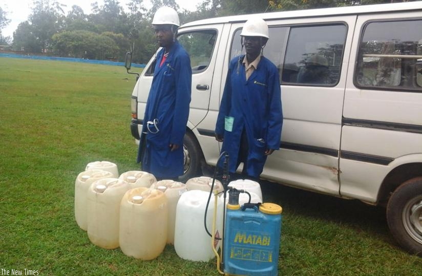 Africhem Rwanda Ltd staff prepare to spray the Kicuriko cricket oval. (Courtesy)