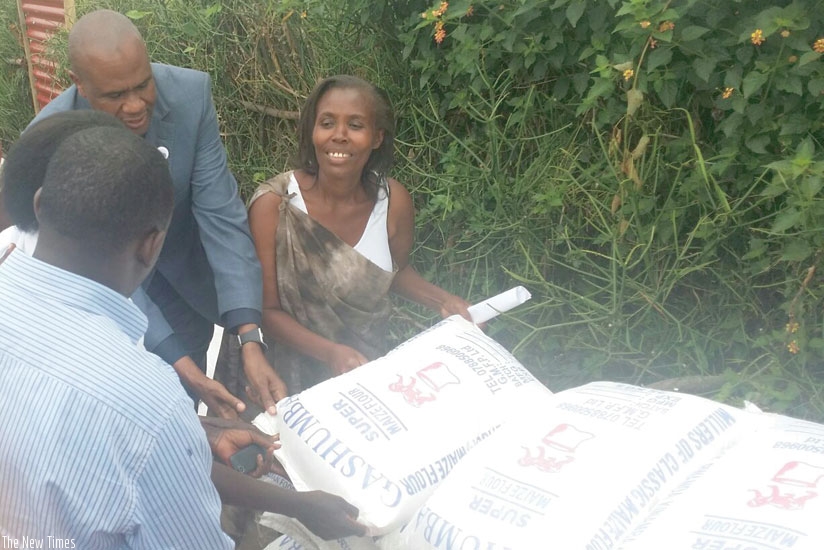 Mirenge hands over the donations to the survivors. (John Mbanda)