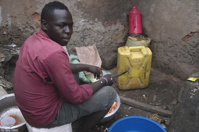 Fabien Twagirimana, a house help in Kimironko, Gasabo prepares  food. (Jean Nepo Ndikumana)rn