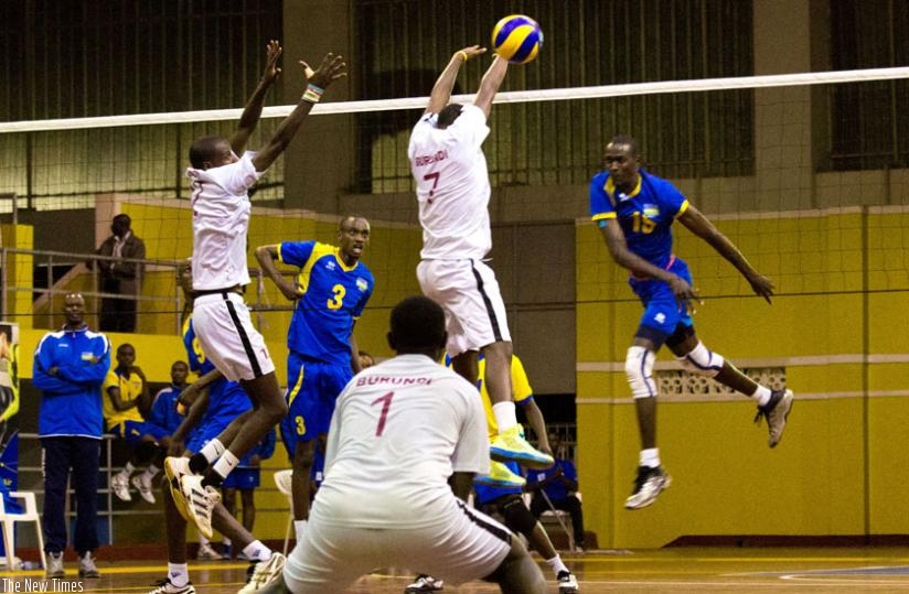 Burundian players try to block Nelson Murangwa's strong spike in yesterday's Zone V volleyball tie which Rwanda won comfortably 3-0. (Timothy Kisambira)