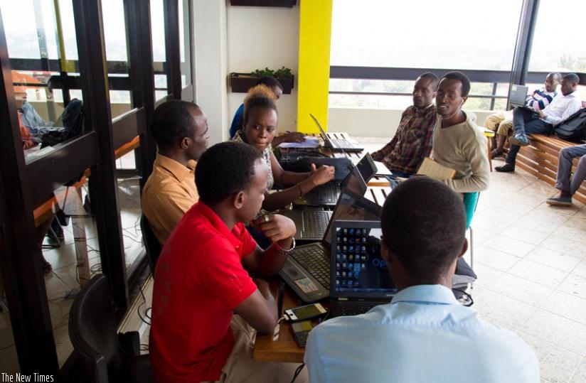 A group of young technicians at K-lab share ideas on the importance of ICT in development. (Timothy Kisambira)