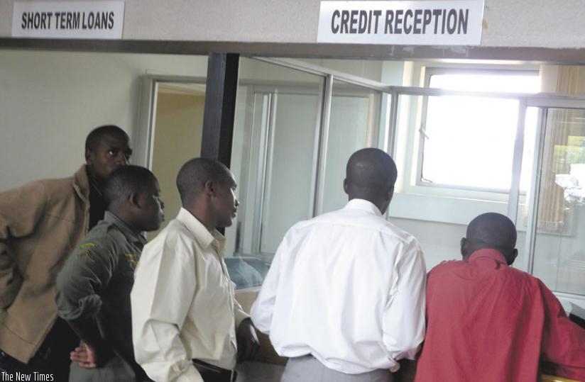 Customers queue to get service at a micro-finance.