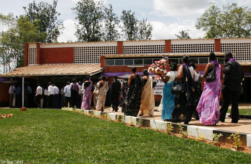 Mourners pay tribute to the victims of the Genocide against the Tutsi at Ntarama memorial site in 2013.  The former church is one of several catholic places of worship that have since turned into memorial sites after thousands were killed from there in 1994. (File)