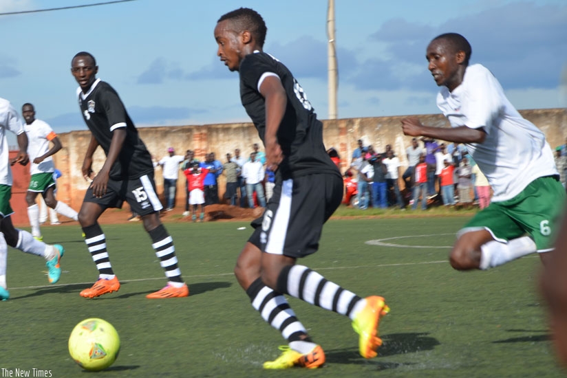 APR striker Yannick Mukunzi races past a Kiyovu defender in a game the army side won 2-0 and now need just a point from their last two games to seal a 15th league title. (Sam Ngendahimana)