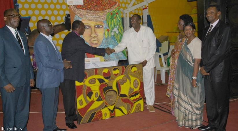 Gahini Diocese Bishop Alexis Birindabagabo (3rd left) shakes hands with Gen. Salim Saleh, who represented President Museveni at the fundraiser, while High Commissioner Frank Mugambage (R), Denis Karera (2nd left), the construction committee chair, and others, look on, in Kampala on Sunday. (G. Muramira)