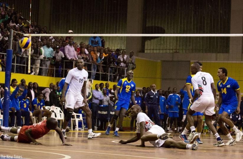 National volleyball team players celebrate after scoring a point in the 3-2 win over Kenya on Monday. Coach Paul Bitok wants early preparations for the team ahead of the All Africa Games. (T. Kisambira)