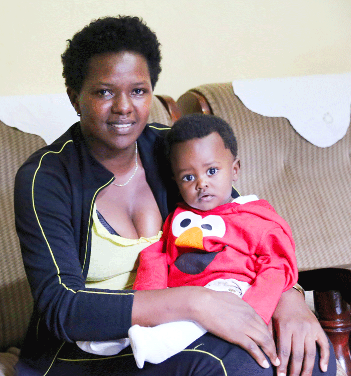 Ingabire and her son at home during the interview. (Dennis Agaba)
