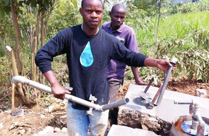 The graduate of Oklahoma Christian University helps build a water pump in a village.
