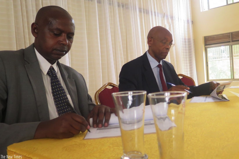 Gatabarwa (L)  signs a Performance contract along with Mugabo. (T.Kisambira)