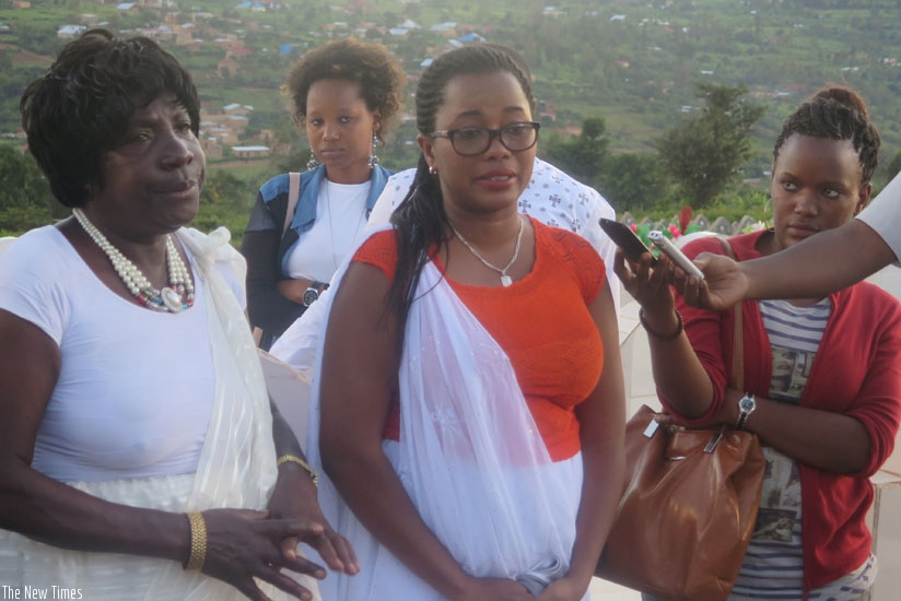 Patrick Kanyamibwau2019s mother (L) and widow at Rusororo cemetery. (Stephen Kalimba)