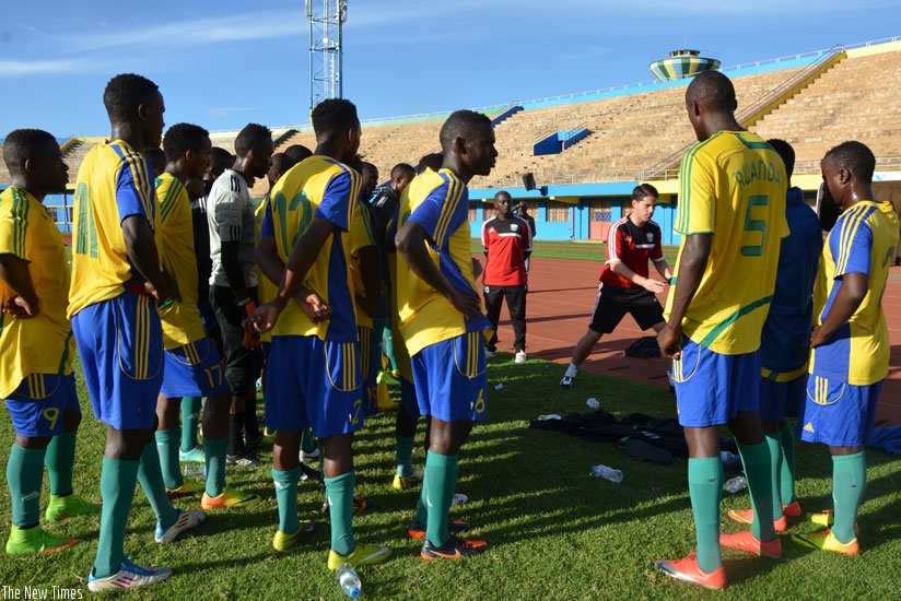 Amavubi players listen to coach Johnny Mckinstry during a training session. Better performances from the national side will see Rwanda improve further in Fifa rankings. (Sam Ngendahimana)