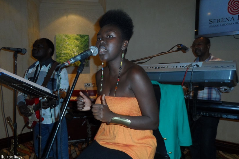 Prudence (R) performing at the Kigali Serena Hotel lobby.