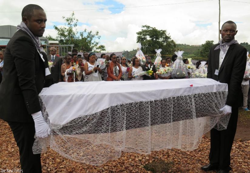 Pallbearers carry one of the caskets containing the remains of Genocide victims during the reburial at Rukira Genocide memorial in  Huye District on Saturday. (Emmanuel Ntirenganya)