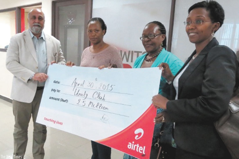 (L-R) Mr. Bhullar hands over the cheque to Ms. Eutochie Sezibera, Ms. Iyamuremye and Ms. Coletha Ruhamya from Unity Club. (Courtesy)