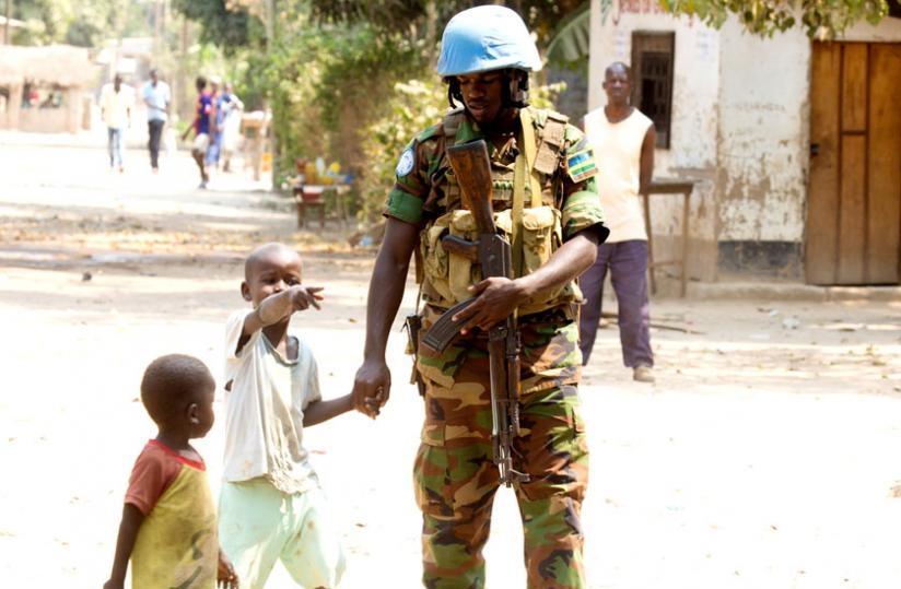 An RDF peacekeeper chats with children in Bangui last year. (Timothy Kisambira)