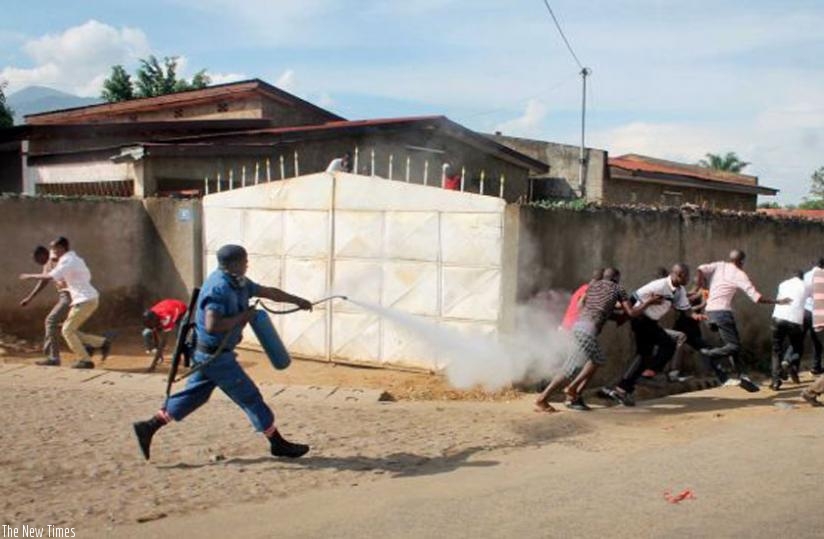 A police officer fires tear gas at protesters in Bujumbura. (Net photo)
