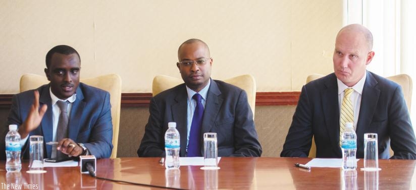 Aimable Nkuranga (left), the firm's country manager, speaks at the press briefing at the Kigali Serena Hotel, flanked by Steven Kamau, the business development manager and Grant Phillips, the chief executive. (Timothy Kisambira)