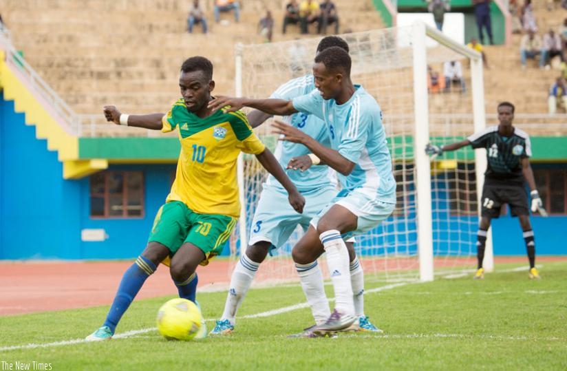 Amavubi U-23 midfielder Bonfils Kabanda tries to get past two Somalia defenders in the first leg tie which Rwanda won 2-0. Amavubi coach expects a tougher challenge from the Uganda Kobs. (Timothy Kisambira)