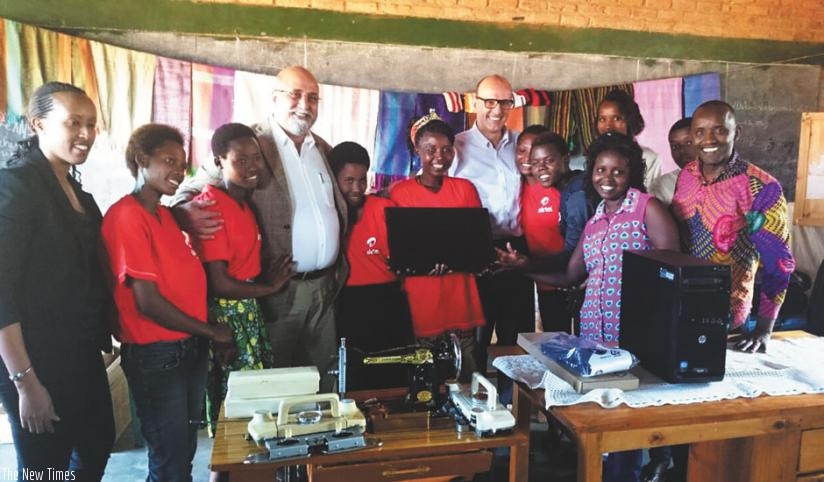 Bhullar(third left) and Soulet (fifth right) pose for a picture with the beneficiaries after handing over the equipment. (Courtesy photo)