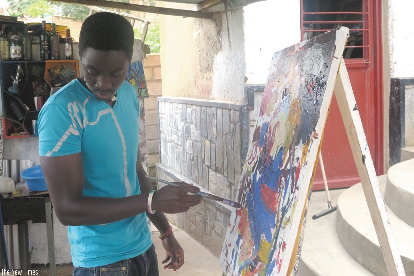 Moses Izabiriza works on one of his pieces at Ivuka art gallery, in Kacyiru. (Arnold Agaba)