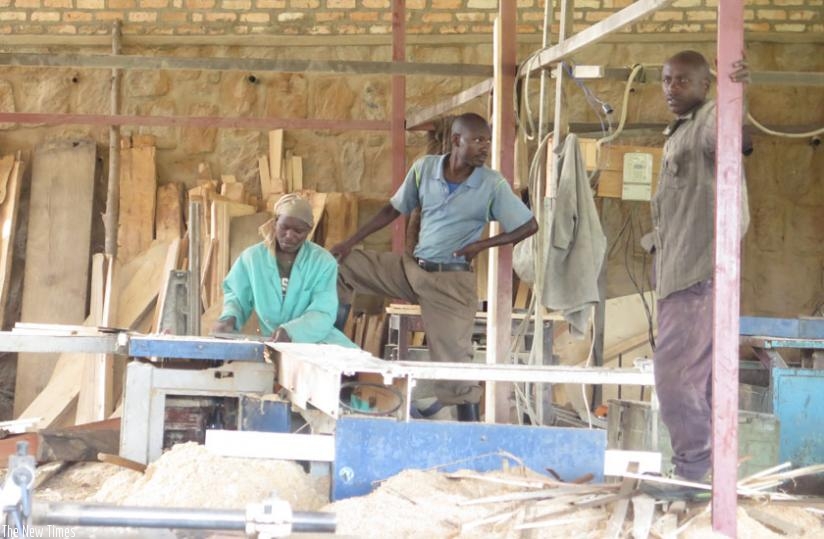 COOANYA members at work last week. The co-operative brings tother 30 individuals and firms involved in carpentry in Nyamagabe town. (Dennis Agaba)