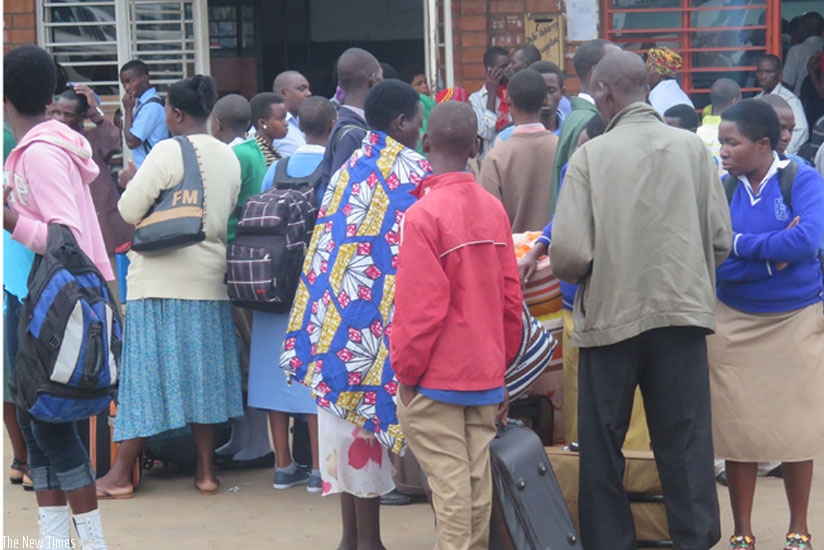 Learners wait for vehicles in Nyabugogo taxi Park at the start of last term.  Experts say parents should spend more time with their children if they are to impart certain values in them. (Solomon Asaba)