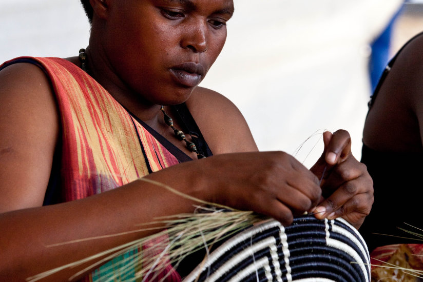 A woman weaving a basket. These are some of the products that Rwanda exports to the US. (Timothy Kisambira)