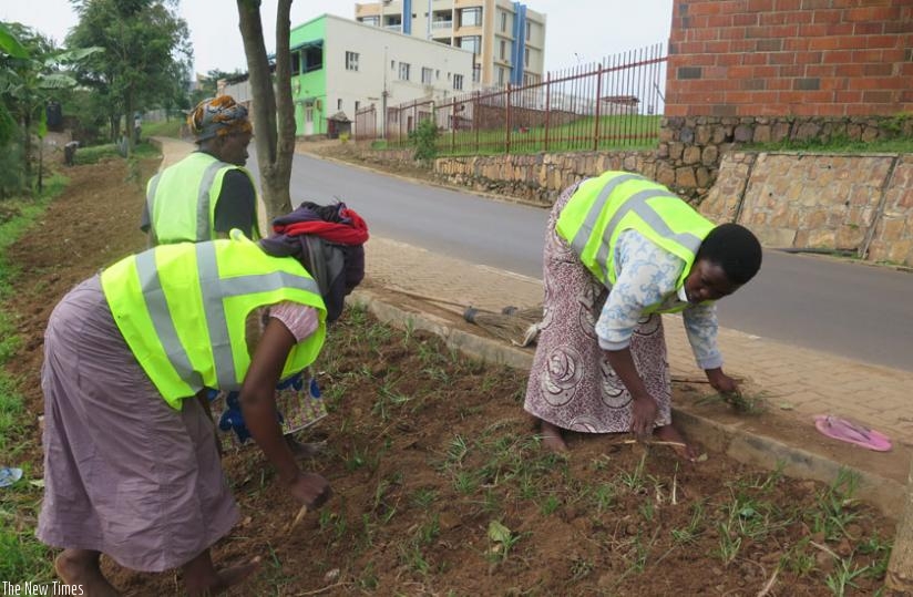 Some of the women during a greening exercise on the Minijust-Prester House by-pass in Kimihurura this week.