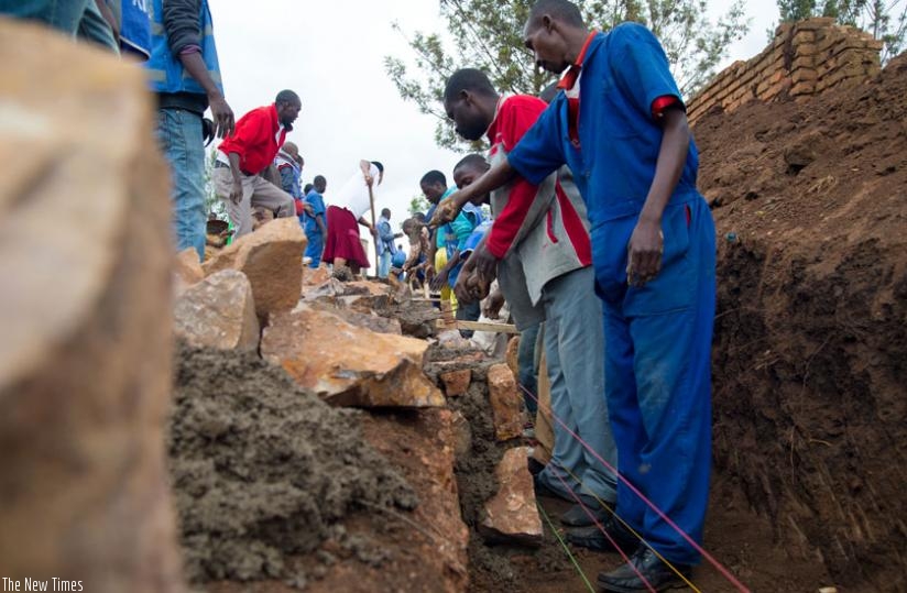 Residents of Kinyinya constuct a water trench during Umuganda in March.(Timothy Kisambira)