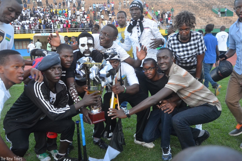 APR fans, who turned up for their team's final league game of the season, pose with the trophy after the army side were crowned champions.