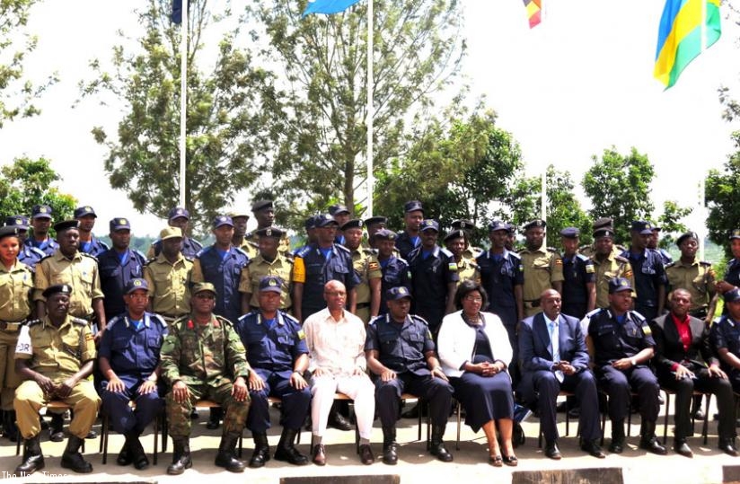 Rwandan and Ugandan Police officers and government officials pose for a photo after  the meeting in Rwamagana District, yesterday. (S. Rwembeho)