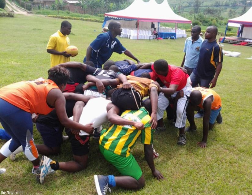 World Rugby instructor, Robert Bwali (standing 2nd from left) conducts a practical session with the coaches. (S. Kalimba)