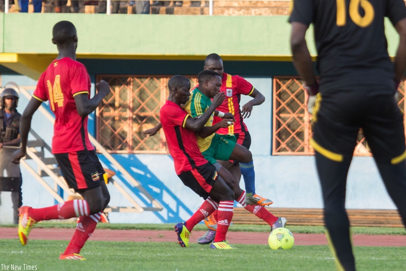 Left back Celestin Ndayishimiye (C) tries to get past Uganda Kobs defenders in the first leg at Amahoro Stadium. Rwanda was eliminated after losing 4-1 on aggregate. (Timothy Kisambira)