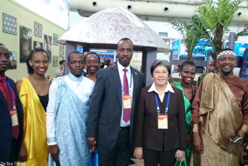Ambassador of Rwanda to China Charles Kayonga (4th right) and Ambassador Extraordinary and Plenipotentiary of the People's Republic of China to the Association of Southeast Asian Nations Yang Xiuping, pose for a photo at the Rwanda stand in Guilin, China. (Courtesy)