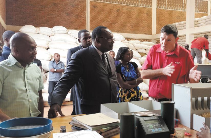 Merwe (right) explains how they test the quality and grade farmers' grains at the an EAX warehouse as Minister for Trade and Industry, Francois Kanimba and EAX chief Kadri look on during a tour of the facility this week. (Courtesy)