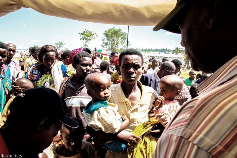 Burundian refugee mothers at Mahama camp queue to have their children immunised. (Timothy Kisambira)