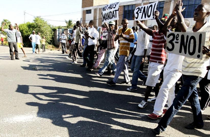 Burundian protesters flash placards denouncing a third term for President Nkurunziza. (Net photo)