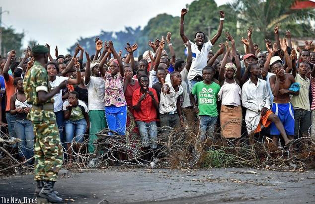 Protestors cheer in front of a barricade during a demonstration against the Burundian President's third term candidature in the Cibitoke neighborhood of Bujumbura on May 22, 2015.(AFP/File)