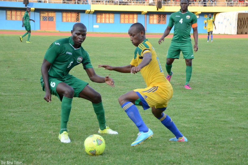 Rwandan playmaker Jean-Claude Iranzi tries to go past Kenya's Anthony Akumu as Southampton's Victor Wanyama (with armband) looks on. (Sam Ngendahimana)