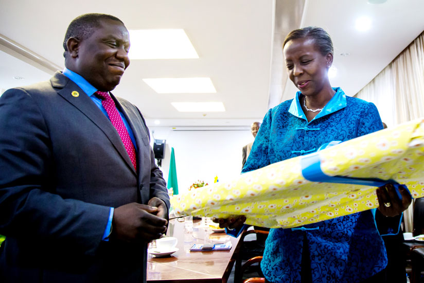 Mushikiwabo (R) receives a gift from her Zambian counterpart Kalaba after the meeting yesterday. (Timothy Kisambira)