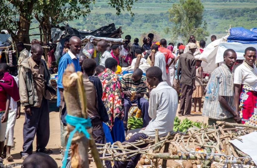 Burundian refugees at a flea market in Mahama camp. (Timothy Kisambira)