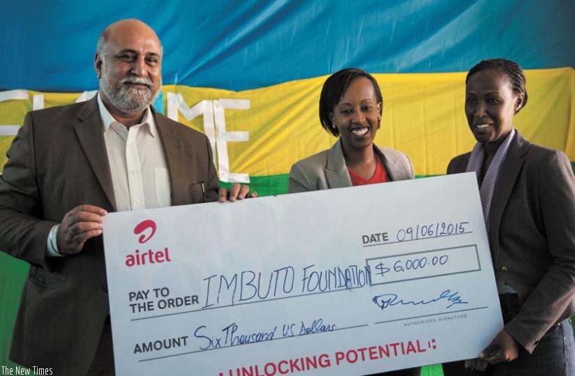 L-R: Airtel chief Bhullar (left), Denise Umunyana, the Airtel head of CSR and Imbuto's Diana Gitera pose with the sponsorship dummy cheque at the hand over event. (Teddy Kamanzi)